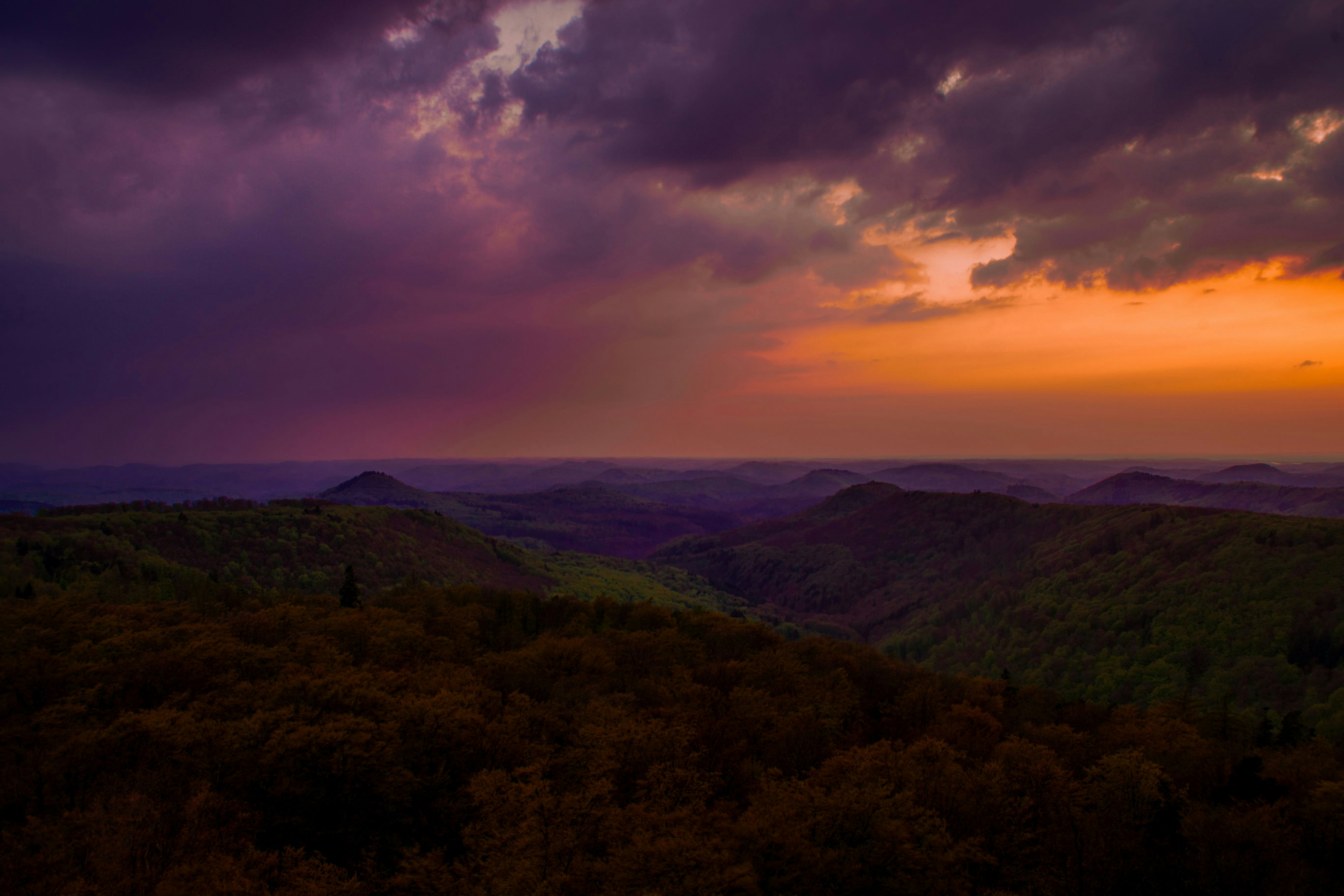 green mountains under cloudy sky during daytime